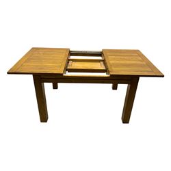 Contemporary oak dining table, rectangular panelled top with integral extension leaf, raised on square supports; set of four oak ladder-back chairs with padded brown seats