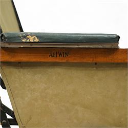 *Early 20th century invalid chair, the tubular metal frame with folding mechanism, canvas seat and back, padded armrests, raised on coil springs and large spoked wheels with wooden footrestFrom the Kirkham Hall Attic & Cellar Collection, sold without reserve