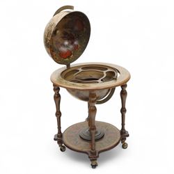 20th century Italian design drinks globe, the hinged celestial printed sphere enclosing a fitted bottle and glass compartment, circular base decorated with zodiac signs and mounted on turned supports with castors