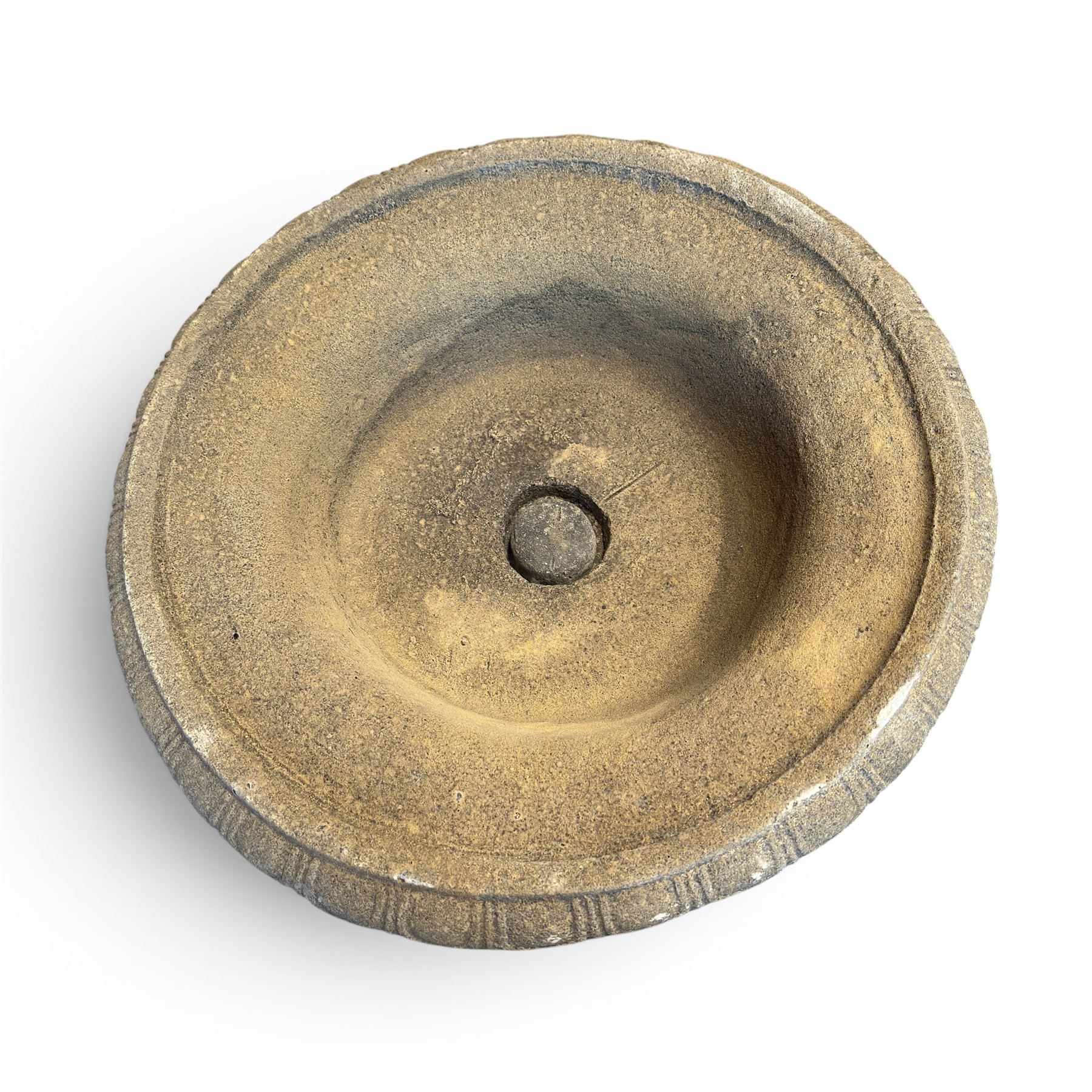 Pair of cast stone garden urns of kylix form on pedestals, the broad egg-and-dart moulded rim over a shallow gadrooned underbelly, with waisted tapering base, raised on matching plinth bases with faux panelled facia