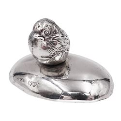 Edwardian silver finial, modelled as a hatching chick, mounted upon a filled silver oval base, both hallmarked Sampson Mordan & Co, Chester 1908, H3.5cm, W6.5cm
