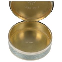Early 20th century silver and guilloche enamel trinket box, of circular form, decorated throughout with pale green guilloche enamel and a floral wreath to the hinged cover, opening to reveal a gilt interior with personal engraving, import marks for Erich Kellerman, London 1909, D6cm