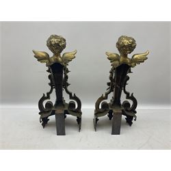 Pair of brass fire kerb supports, each modelled as the bust of a putto above a floral swag and musical trophy, H43cm
