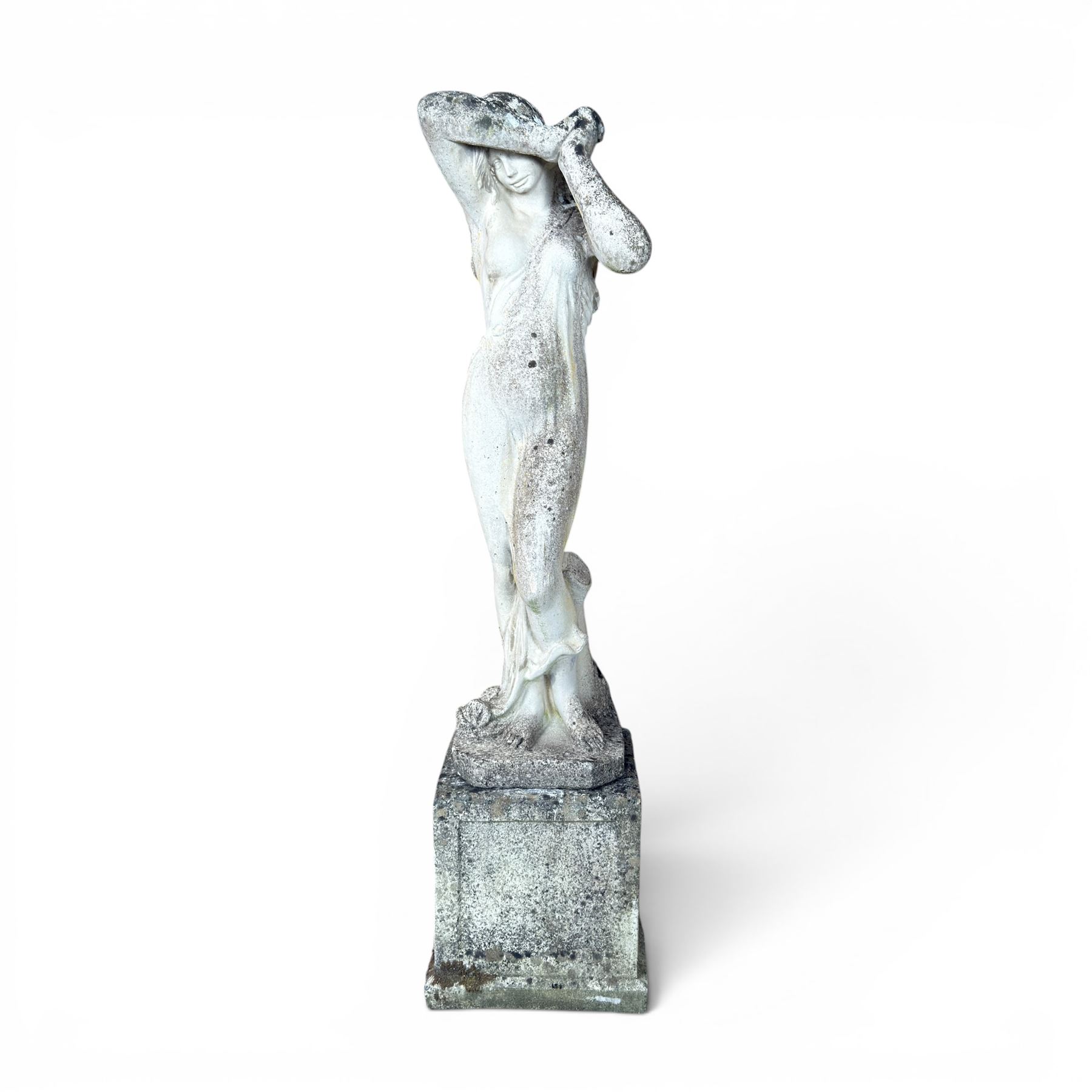 Weathered cast stone garden statue of a 'Shy Maiden', raised on square plinth base