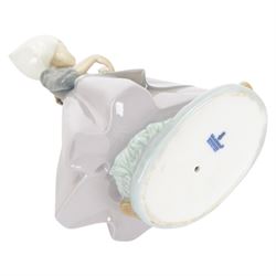 Three Lladro figures, comprising Spring Awakening 1283, Flower Harmony 1418 and Dutch girl with Tulips 5065