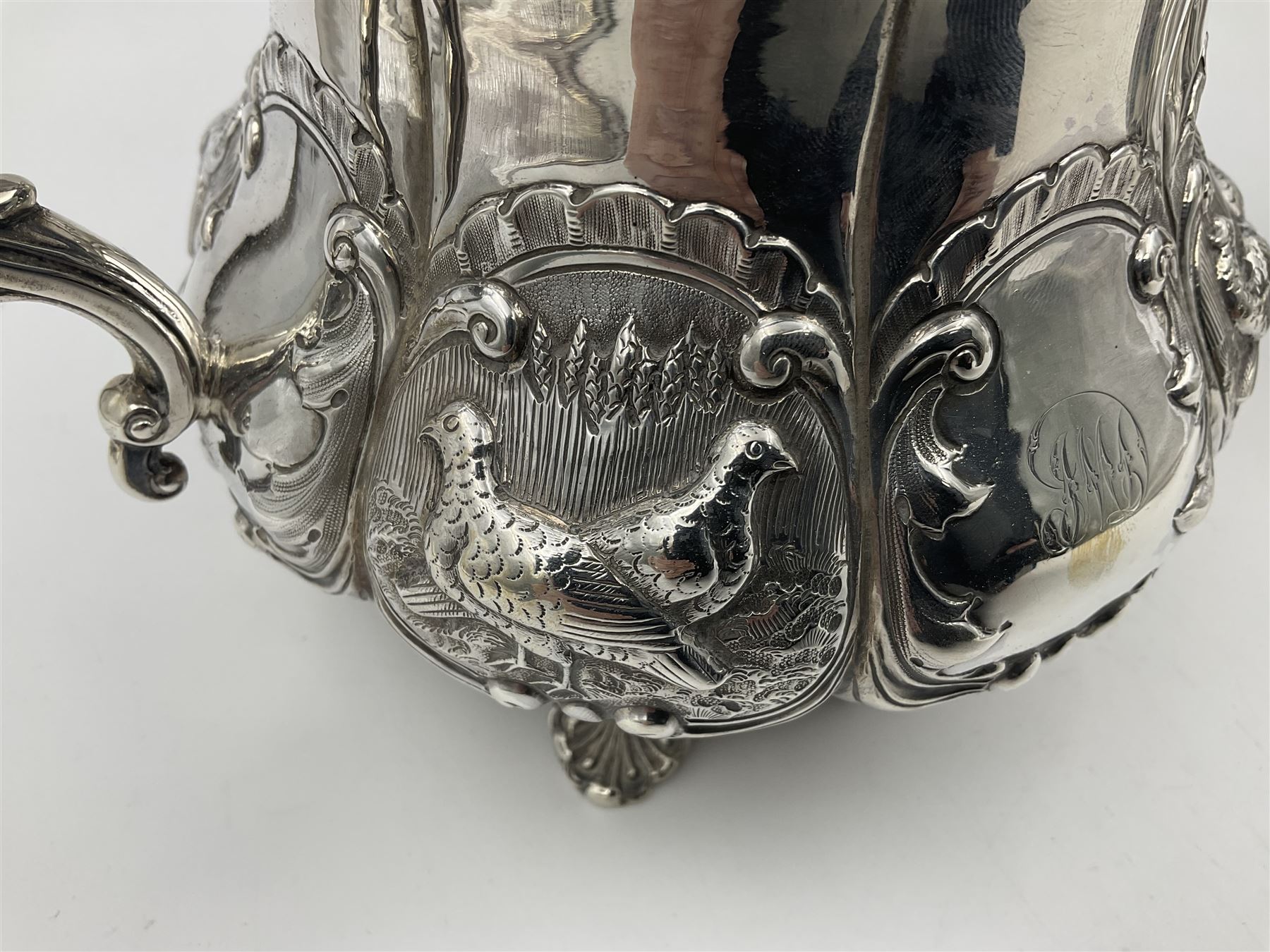 Victorian silver three piece tea service, comprising teapot, twin handled open sucrier, and milk jug, each of bellied form with acanthus capped scroll handles, the sides embossed with alternating scroll edged vacant panels and panels containing a pair of birds, upon four palmette feet, the teapot with ivory insulators to handle, and bird finial to the hinged domed cover, hallmarked William Hunter & Son, London 1861, teapot H19cm, including handles sucrier H13.5cm, including handle milk jug H12cm

This item has been registered for sale under Section 10 of the APHA Ivory Act