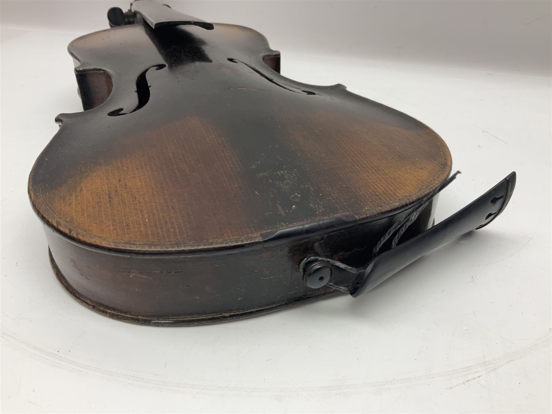 German violin c1890 with 36cm two-piece maple back and ribs and spruce top; bears label 'Antonius Stradivarius Cremona Faciebat Anno 1729' L59.5cm overall; in ebonised wooden 'coffin' case; and two German violins c1890 for completion - one bearing a Stradivarius label, the other a Ruggeri label; both in carrying cases (3)
