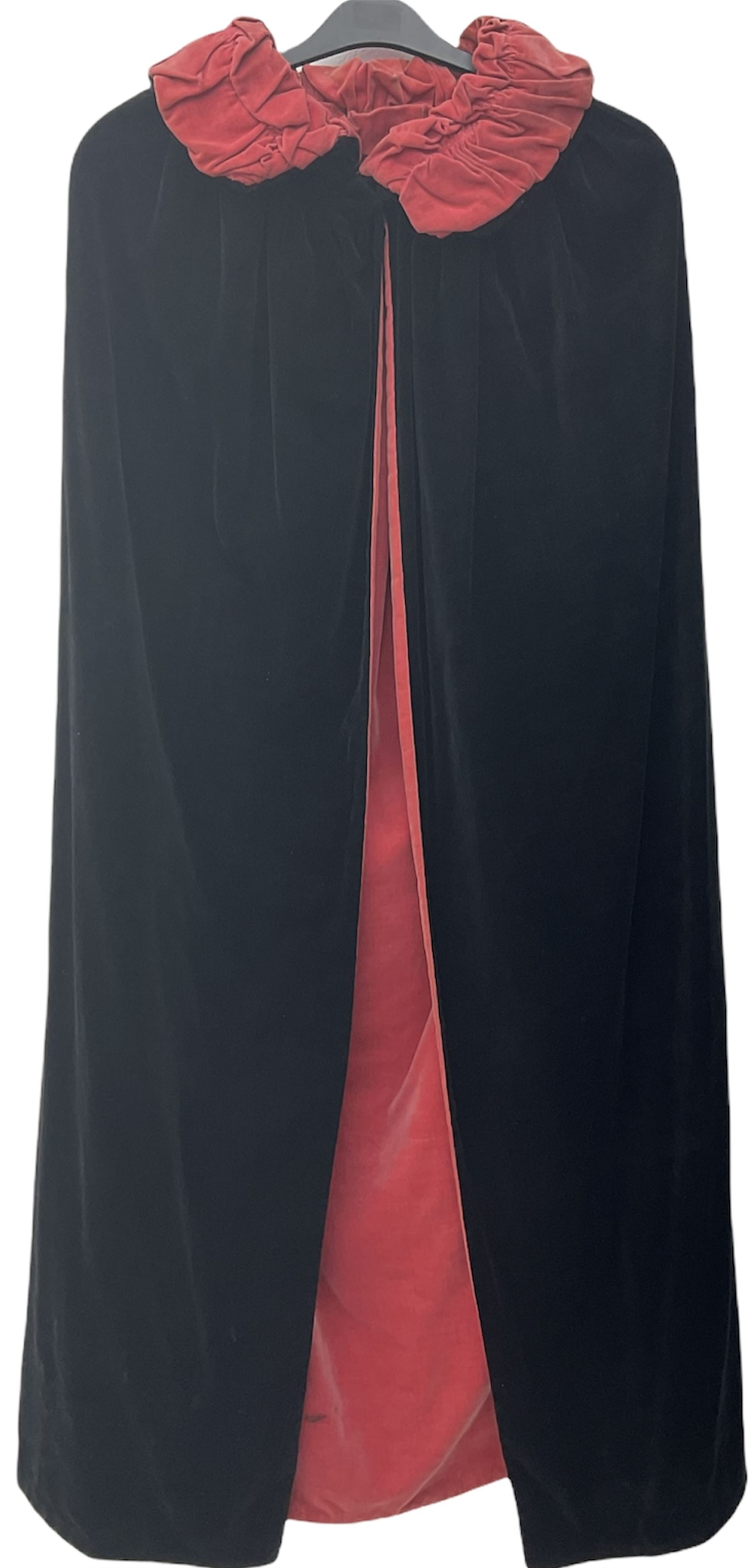 Full length 1930's childs black velvet cape, with ruched collar and red velvet lining, with a single button neck fastening 
