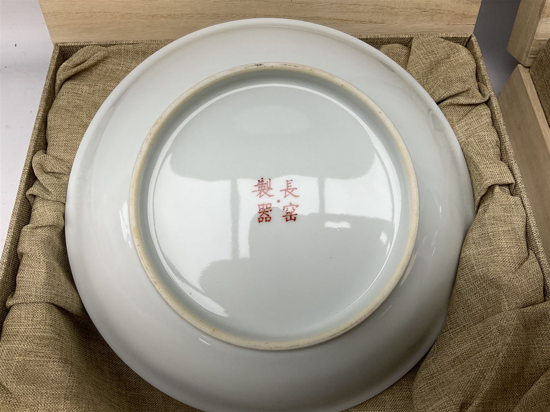 Three Chinese polychrome enamel plates each decorated with floral decoration, all marked beneath, D21cm 