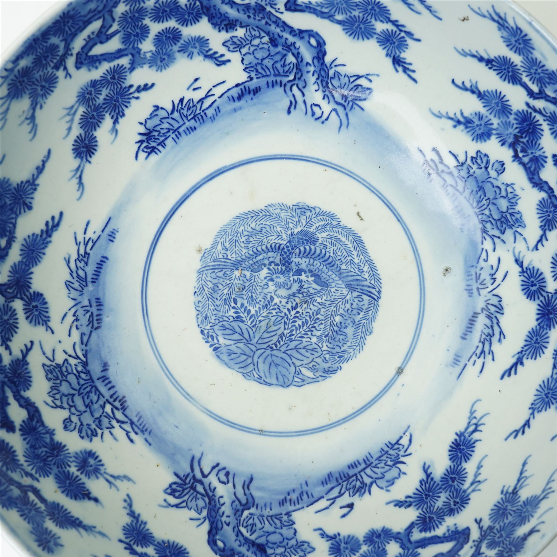 Japanese blue and white bowl, the central bowl painted with bird, surrounded by a border of trees, unmarked, D31cm 