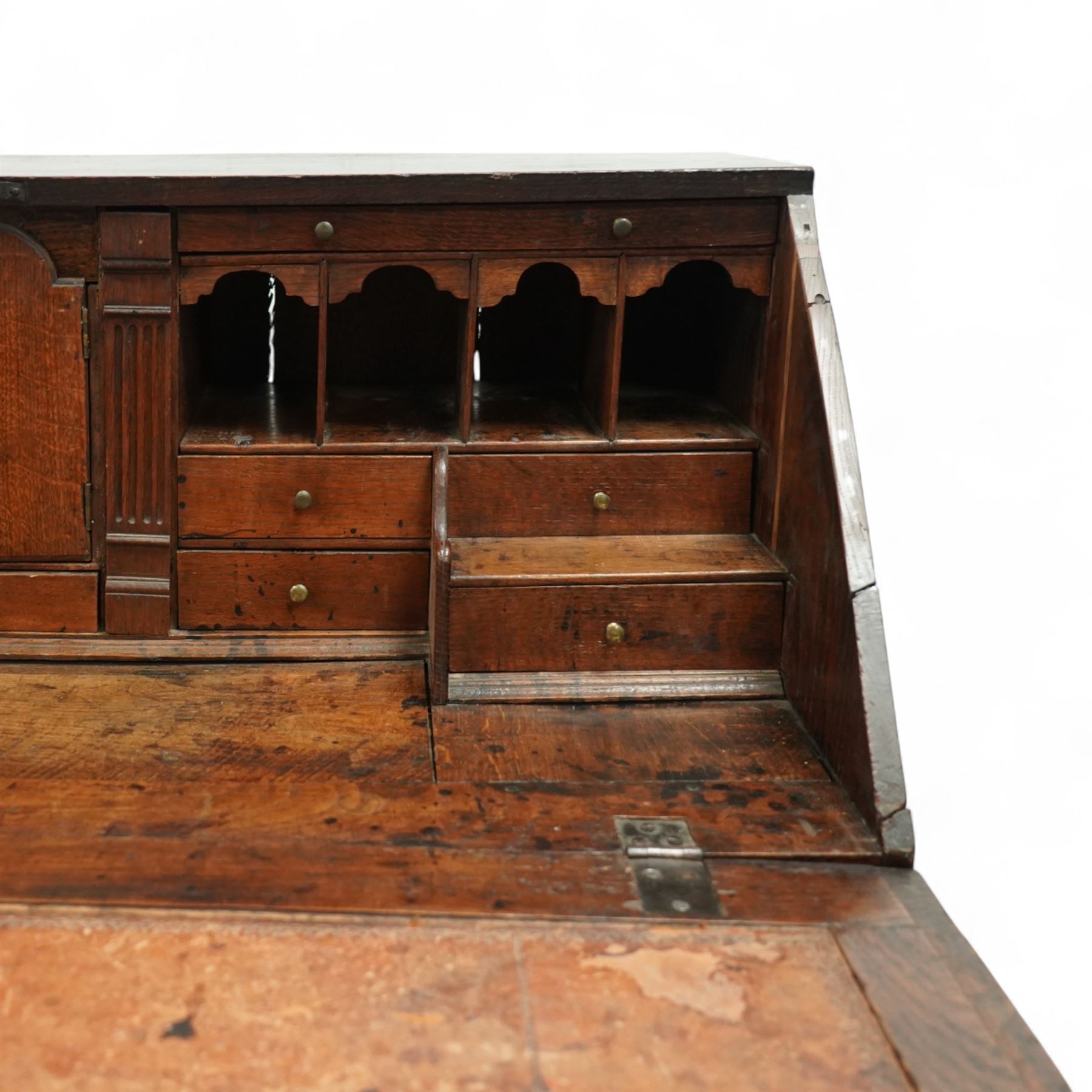 George III oak bureau, the fall front enclosing a fitted interior of small drawers and pigeonholes, above seven graduated drawers with brass plate handles and bone escutcheons, raised on bracket feet