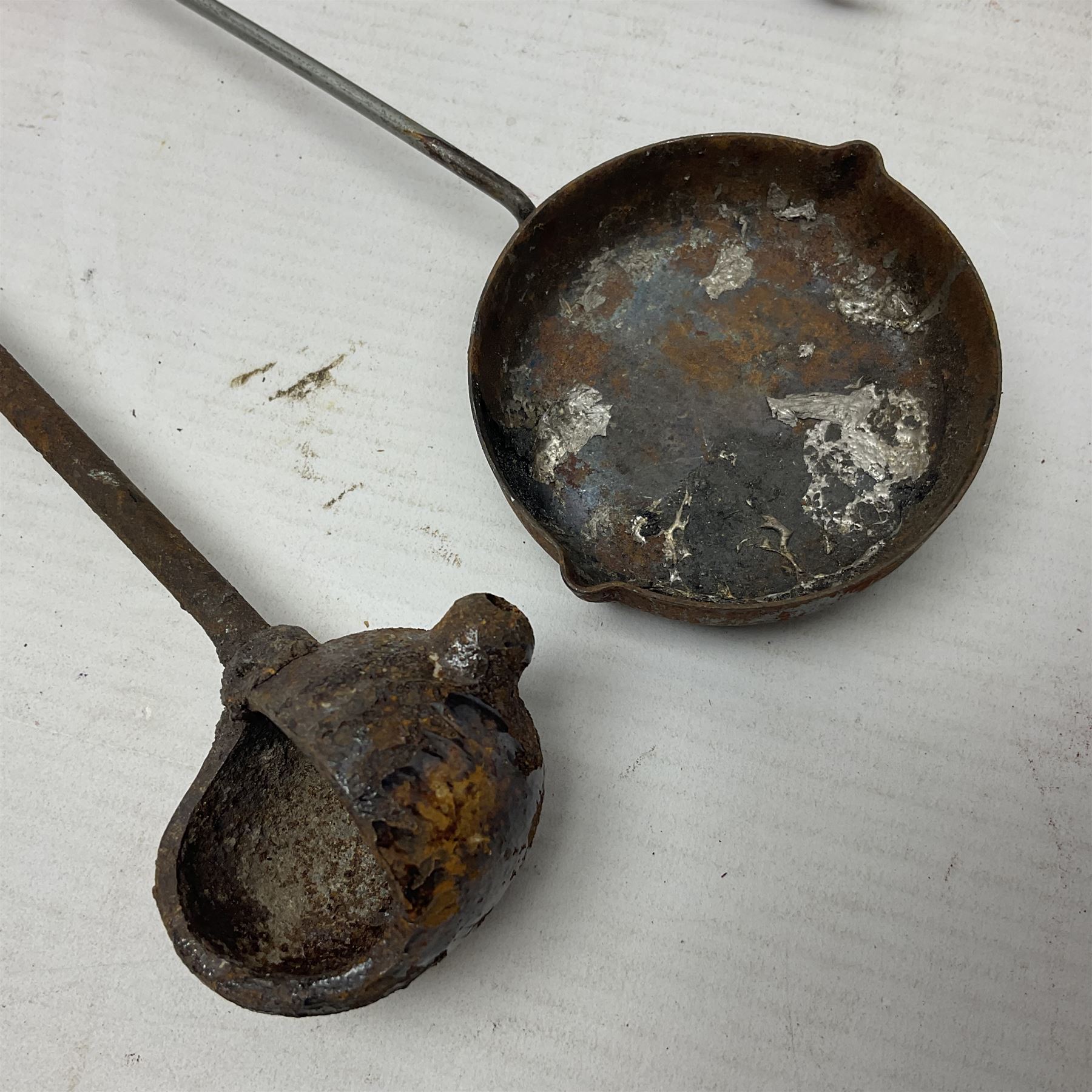 Two leather shot flasks with embossed decoration and brass nozzles; scissor action bullet mould with two ladles; pair of 19th century J.B. Warrilow hammer actions; small quantity of Staybrite buttons; and 1968 dated metal ammunition tin for 200 x 7.62 blank cartridges
