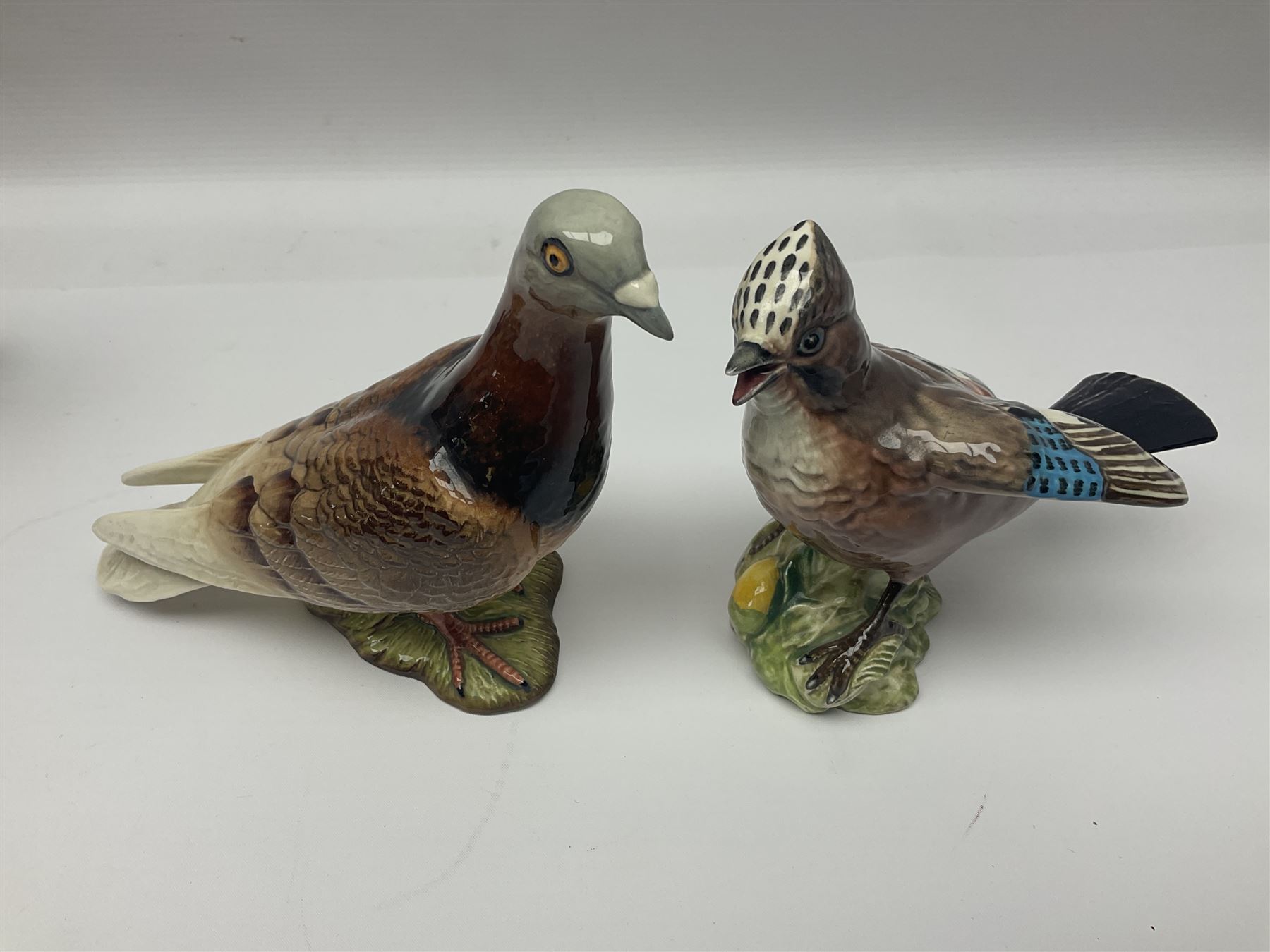 Collection twenty one of Beswick bird figures, to include Lapwing no 2416, Kingfisher no 2671, Red Pigeon 1383, Cuckoo no 2315, Nuthatch no 2418 etc