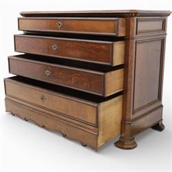 Late 19th century French provincial oak chest of drawers, moulded rectangular top with carved rope edge over four graduated long drawers with raised and fielded panels and ornate cast handles, canted angles and shaped apron below, standing on moulded block feet,