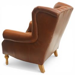 Alexander James design fully tan leather chair, with full button back seat and back, with scrolled arms with studded trim, raised on light stained turned supports