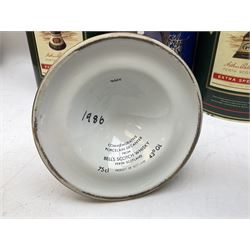 Bells, Scotch whisky, in seven Wade ceramic decanters, comprising two Christmas decanters 1990 and 1991, 60th birthday of Queen Elizabeth II decanter, Golden Wedding anniversary of the Queen and the Duke of Edinburgh decanter, Birth of Princess Beatrice decanter, Birth of Princess Eugenie decanter and Queen's mothers, together with Bells, blended Scotch whiskies, three miniatures in Wade ceramic decanters, various contents and proofs