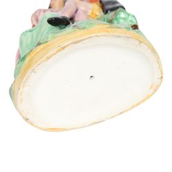 Rare Staffordshire pottery figure group, circa 1852, modelled as Romeo and Juliet, both seated upon a naturalistic base with their arms around one another, Romeo wearing cloak and plumed hat, Juliet in long dress, H20cm