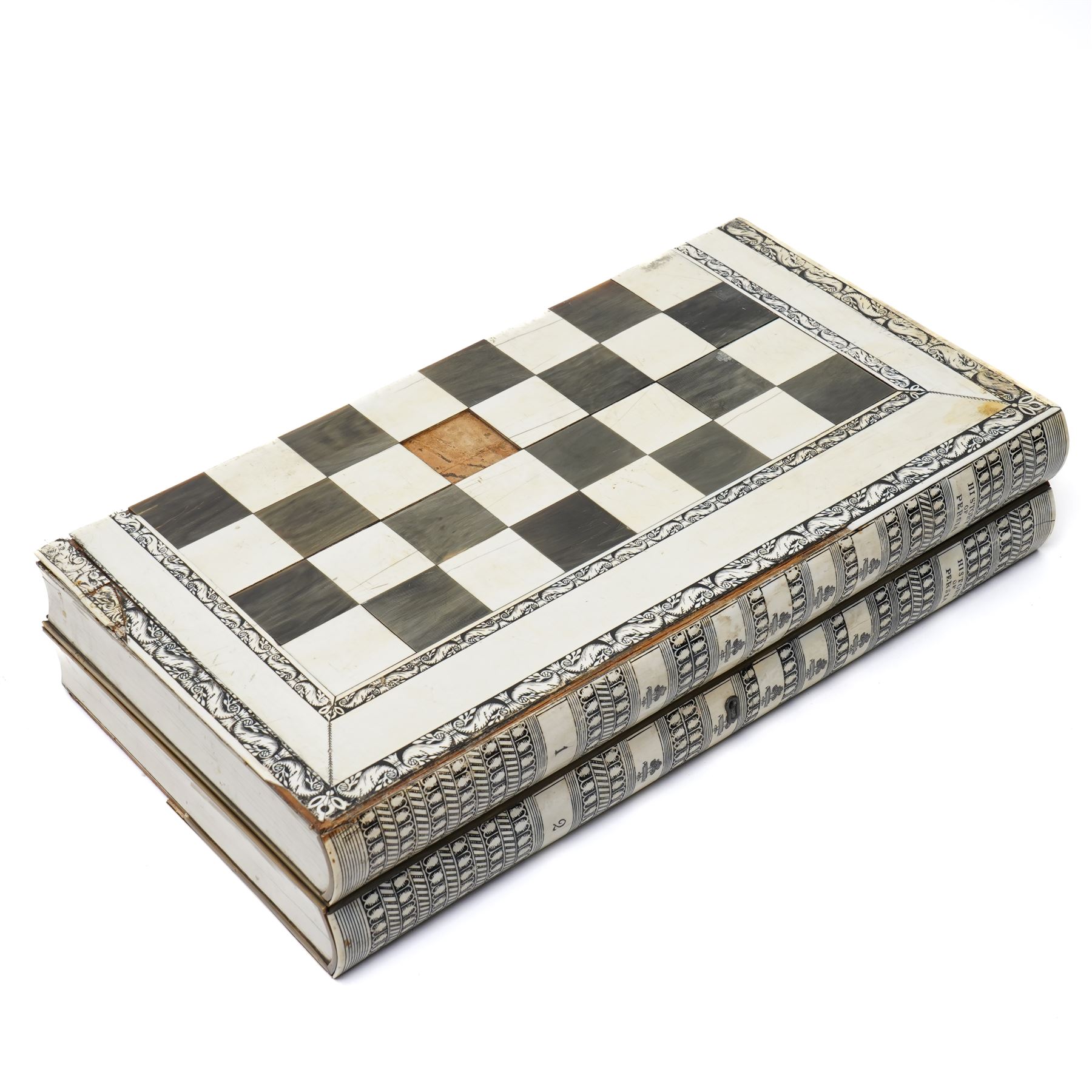 Mid-19th-century Anglo Indian Vizagapatam ivory, sandlewood, and horn veneered backgammon/chess board, circa 1860, rectangular games box the borders engraved with a stylized scrolling leaf decoration and spine engraved History of Persia the interior inlaid for backgammon, with three internal sandalwood boxes with covers, containing 16 ivory pieces and 16 horn pieces, comprising, kings and queens with pierced crowns on baluster carved shafts; bishops with carved mitres; knights represented by horses’ heads; and rooks as towers with imbricated decoration.

This item has been registered for sale under section 10 of the APHA Ivory Act, submission reference G68PNYA5 

