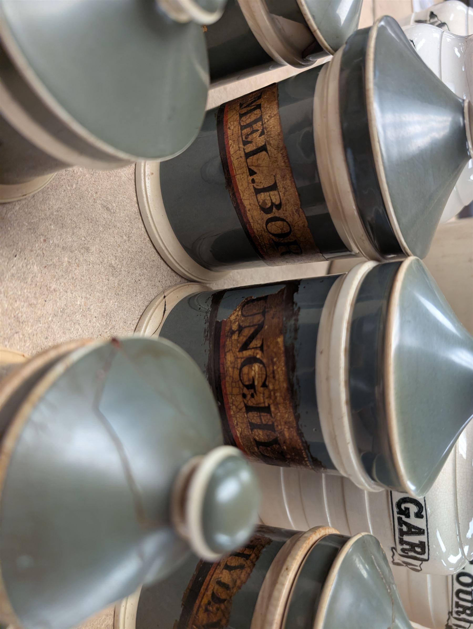19th century sage green apothecary jars with gilt labels, four white ceramic kitchen jars and a stoneware flaggon marked Wheat Wine