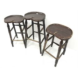 Set three bog oak saddle seat bar stools, turned supports 