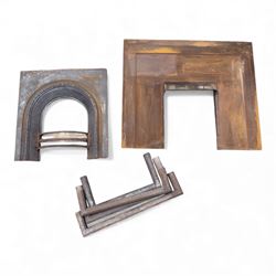 Two cast iron fire surrounds / inserts along with four metal surround pieces 