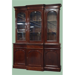  Victorian mahogany library bookcase, projecting cornice, three doors with arched beveled glazing, enclosing adjustable shelves, above three drawers and three cupboards, plinth base, W190cm, H242cm, D52cm  