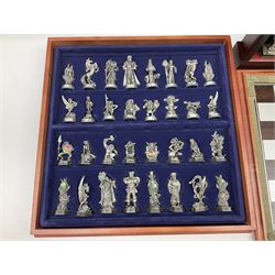Danbury Mint 'The Fantasy of the Crystal' chess set consisting of mythical pewter chess pieces within a wooden case with chess board lid, together with 16 additional chess pieces in a wooden display case.