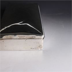 Two silver cigarette boxes, comprising early 20th century plain rectangular example with compartmentalised softwood interior, hallmarked Birmingham 1914, maker's mark indistinct, and an early 20th century example with engine turned decoration and engraved initials to cover, hallmarks worn and indistinct, largest H4.5cm, W21cm