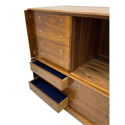 Walnut two sectional military style chest cabinet, the top section enclosed by two hinged and retractable doors, the lower section fitted with six drawers, with Wellington style hinged stays, on plinth base