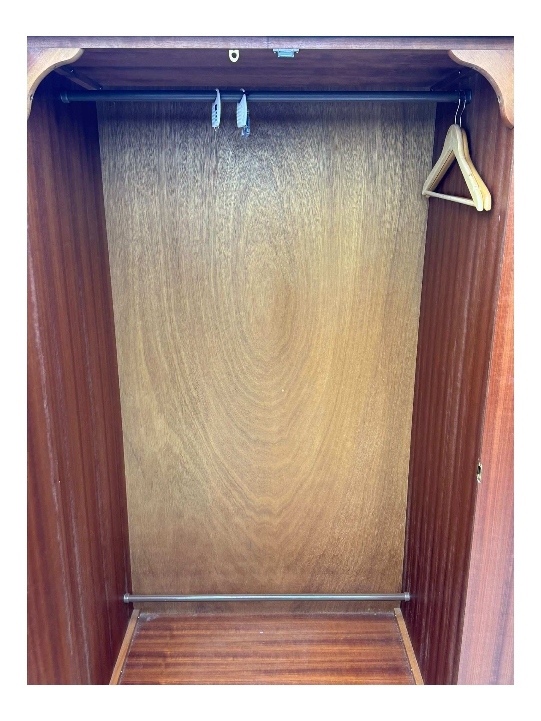 Stag Minstrel - pair of mahogany double wardrobes, comprising a larger wardrobe with a shelf and hanging rail behind two panelled doors (W127cm, D59cm, H177cm); and a smaller wardrobe enclosing a single hanging rail (W96cm, D59cm, H177cm), both finished with projecting cornices and raised on bracket feet



