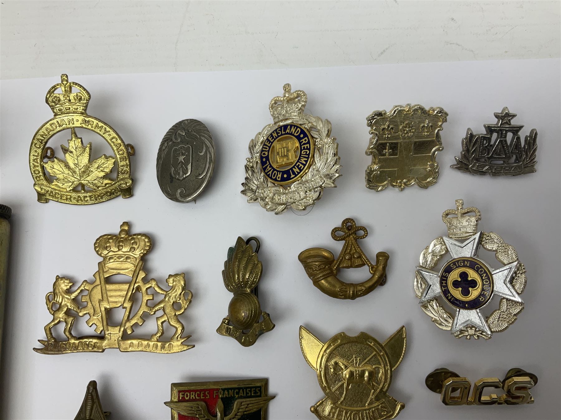 Collection of approximately sixty worldwide medals, metal badges, belt buckles, cloth badges, trench art, brass button stick etc