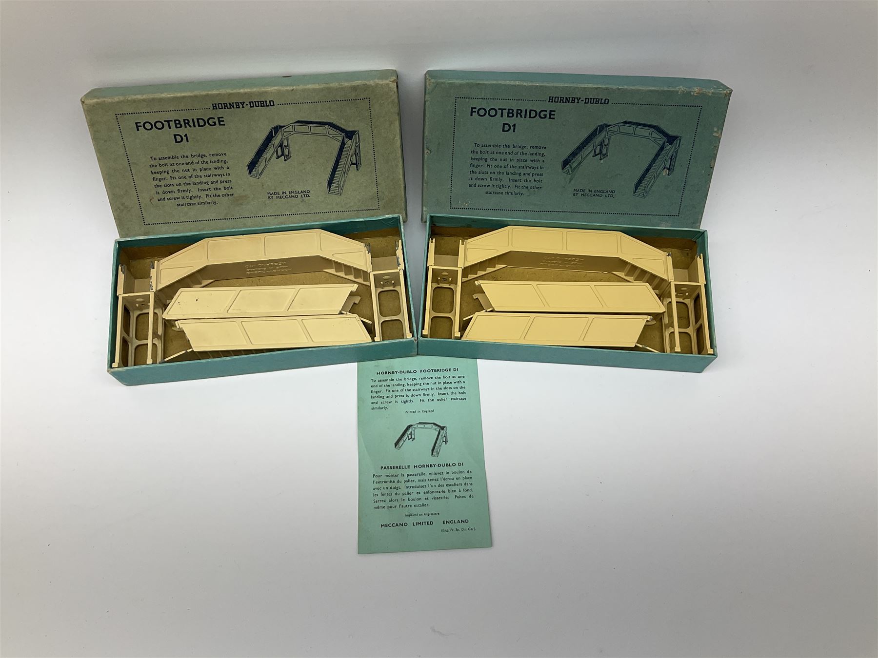 Hornby Dublo - 5080 Signal Cabin with pack of Station Names; two D1 Footbridges, one with instructions; and two 2460 Plastic Level Crossings suitable for two-rail system; 2400 T.P.O. Mail Van Set for two-rail system all boxed; together with three plastic brick effect tunnel mouths for double track layout (9)