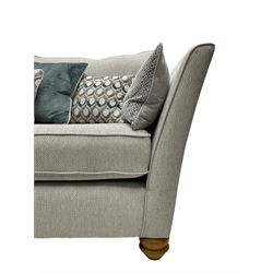 Oak Furnitureland - 'Gainsborough' lounge suite - three seat sofa, out-swept arms with loose cushions on turned oak feet, upholstered in 'Minerva Silver' fabric (W209cm D102cm H80cm); matching armchair or snuggler settee (W125cm); and rectangular ottoman footstool