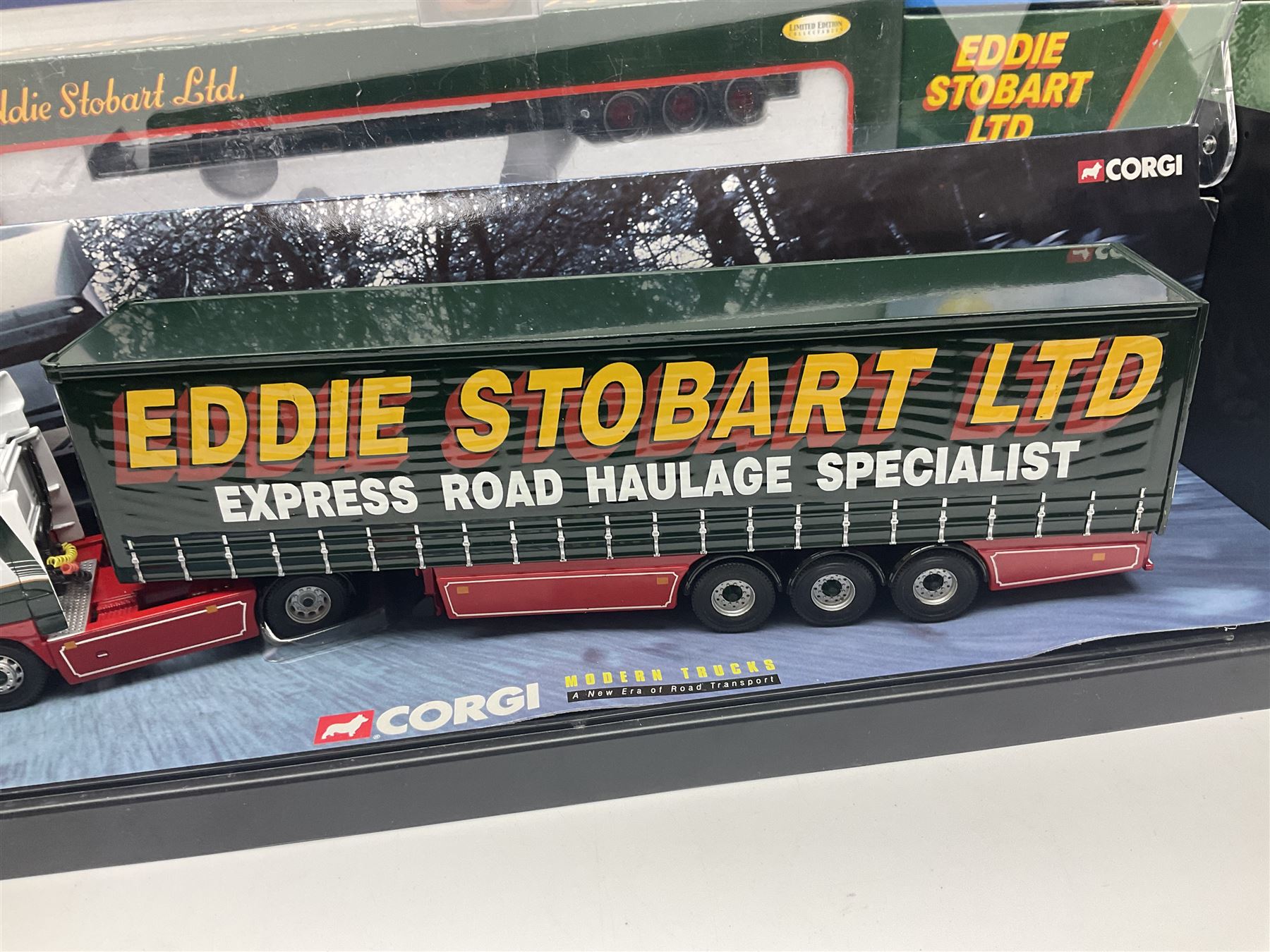 Corgi Eddie Stobart - four heavy haulage vehicles comprising 75201 ERF Curtainside; 75403 Leyland-DAF Curtainside; both in plastic display boxes; CC12610 Scammell Crusader 3 Axle Low Loader; and CC12502 Atkinson Borderer Flatbed Trailer; together with AA30008 Douglas DC-3 Aircraft; all boxed (5)