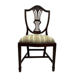 
Late Victorian mahogany extending dining table and four chairs, rectangular top with rounded corners and moulded edge, fitted with two additional leaves, raised on turned and reeded legs with brass castors, with a pair of Victorian mahogany hall chair, with curved top rail and plain splat, padded seat in textured salmon pink fabric, raised on turned and tapering front legs and another pair of early 20th century mahogany dining chair, with shield back and carved pierced splat, serpentine seat rail with striped upholstered cushion, raised on moulded square front legs