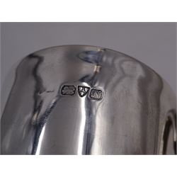 Early 20th century silver christening mug, of tapering cylindrical form, with C handle and personal engraving to centre, upon stepped base, hallmarked Chester 1913, maker's mark worn and indistinct, together with a Victorian silver christening mug, of slightly tapering form, with C handle, later personal engraving to centre and beaded rim to base, hallmarked James Dixon & Sons Ltd, Sheffield 1880, tallest H9cm