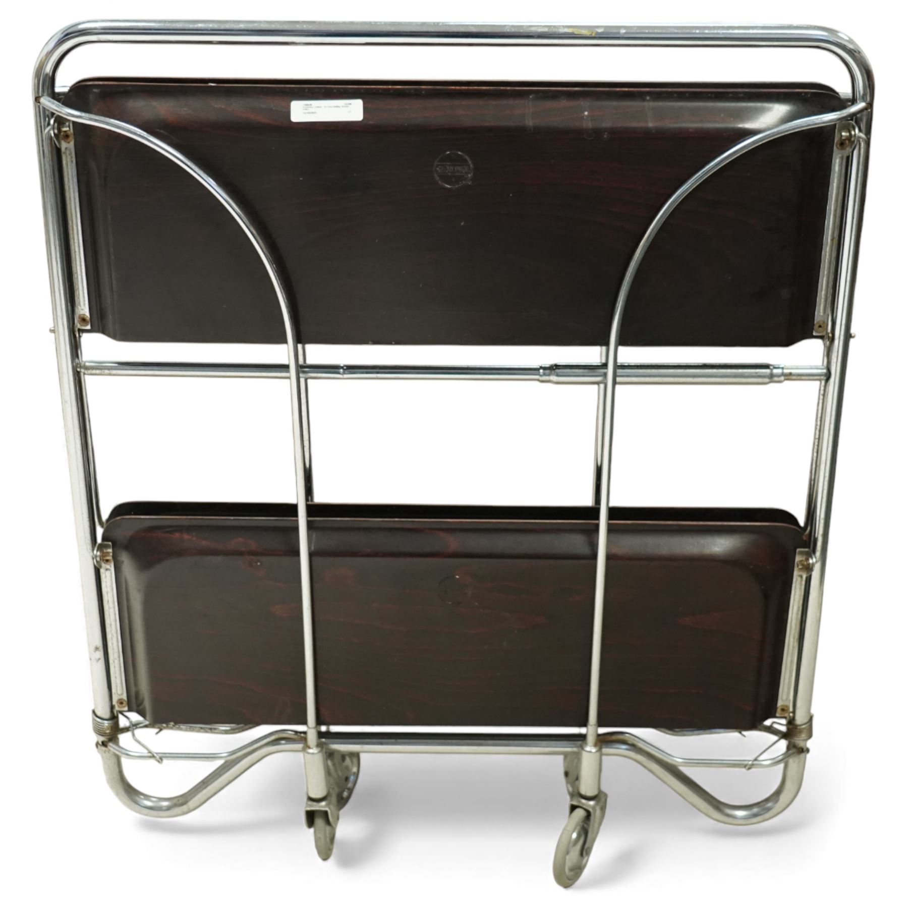 Bremshey Gerlinol - folding trolley, with arched tubular chrome supports and twin dark stained trays, raised on castors, designed to fold compactly when not in use