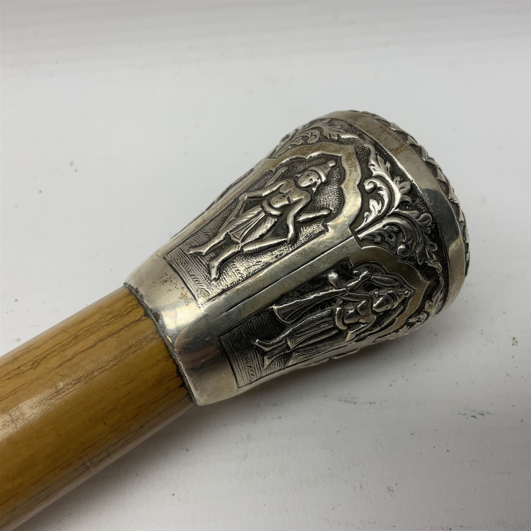 Malacca walking cane, with domed Burmese silver pommel embossed with deities, L91.5cm