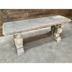 Cast stone garden Rams Head bench, two pillars set with architectural rams heads, rectangular slab seat