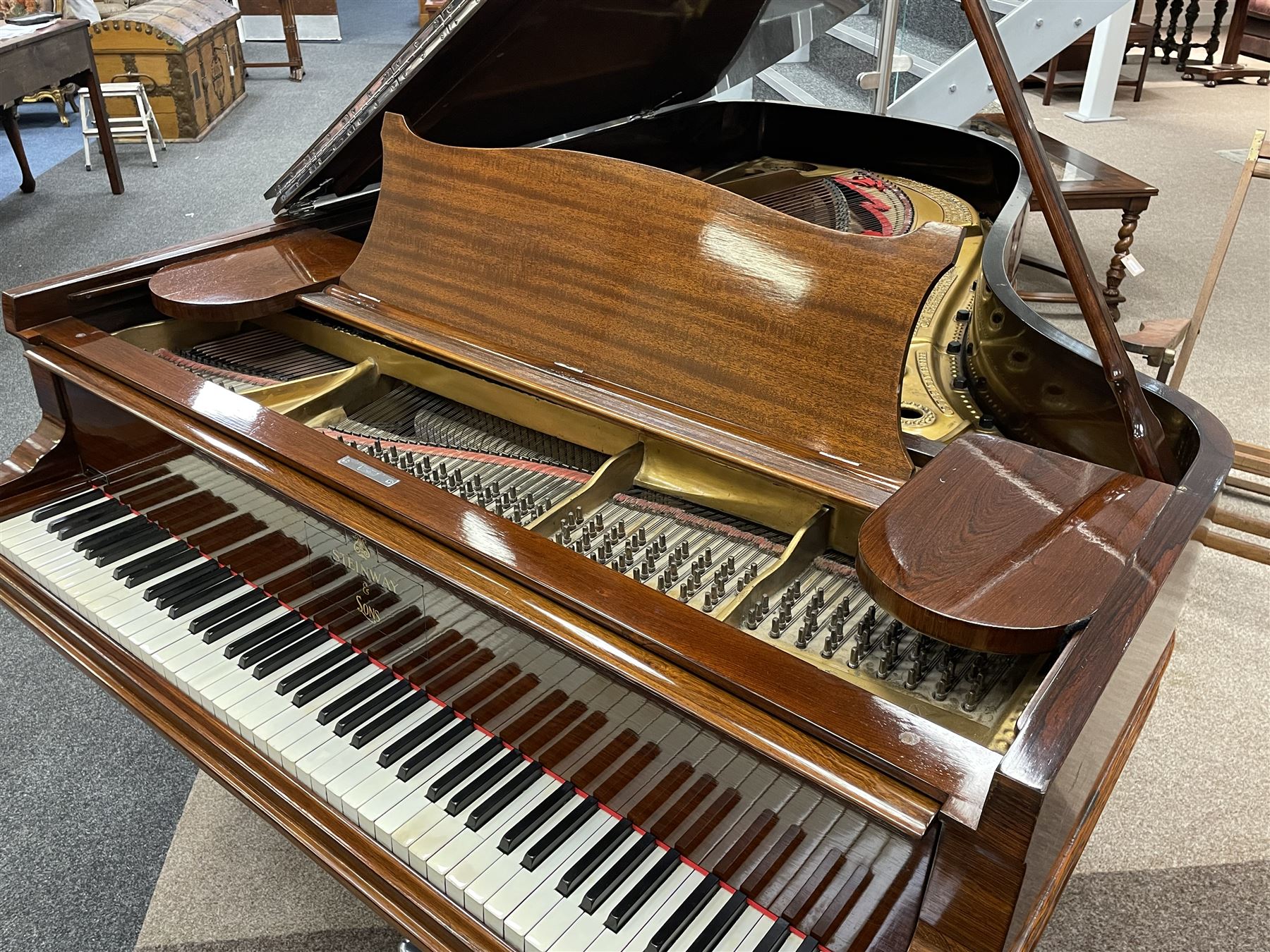 Steinway & Sons – Model B overstrung Drawing Room Grand Piano Serial No 70718 manufactured in Hamburg 1891, with 85 ivory and ebony keys (7 octaves) in a mahogany case with chrome fittings and pedals, Steinway “Fireplug” straight columnar and fluted legs with roller castors and conforming lyre, duplex stringing with agraffs, bass strings copper wound with a steel core, steel tuning pins, original Steinway action, hammers, keys, felts, and dampers, with una-corda, sostenuto and sustain pedals,
Overstrung iron frame detailing numerous Steinway patents, awards, and features. 

This item has been registered for sale under Section 10 of the APHA Ivory Act
