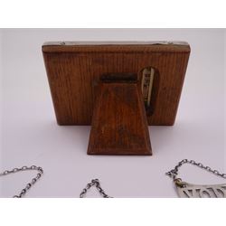 1920s silver mounted perpetual desk calendar, printed in red and black on an ivorine ground, hallmarked Charles S Green & Co Ltd, Birmingham 1925, with wooden easel style support verso, together with a set of three modern silver decanter labels, with cut-out lettering for gin, whisky and vodka, hallmarked London 1982, maker JKM, calendar H8.4cm