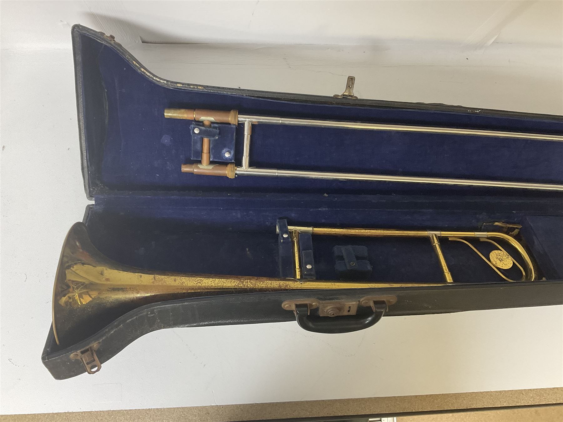 Three brass trombones comprising Elkhart Ind. USA 'CONN' model no.72H; Besson 'Concord'; and Selmer Distributed 'Lincoln'; two in carrying cases; and German B & M 'Champion' brass trumpet (4)