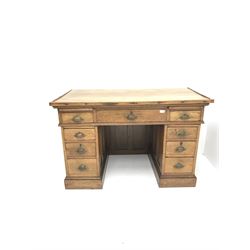 Early 20th century medium oak twin pedestal desk, two slides above nine drawers, plinth base