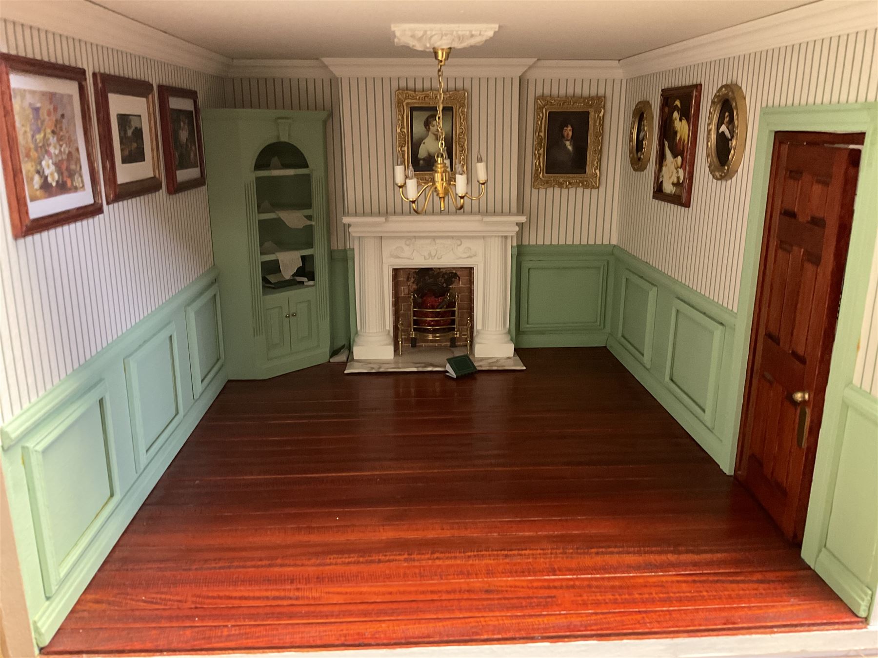 'The Hollies' - good quality sectional wooden doll's house in the form of a Georgian style four-storey bay windowed town house with simulated brick front elevation, rendered sides, off-set corner stonework, faux slate-hung top floor with flat roof and chimney stack, working sash windows, iron railings around front basement courtyard with hinged front elevation to two rooms with  spiral staircase, side hinged central section approached by external steps with iron balustrades to the sides leading to a front door, entrance hall with stairs to landing and two rooms on two floors with dado panelling and fire-surrounds, the top floor with top hung front elevation revealing stairs to a landing and bedroom; wired for electricity L51cm D65cm H107cm including chimney; together with a good quantity of quality wooden furniture and accessories including piano, dressers, bookcase and books, rugs, double half-tester bed, metalware, pictures etc