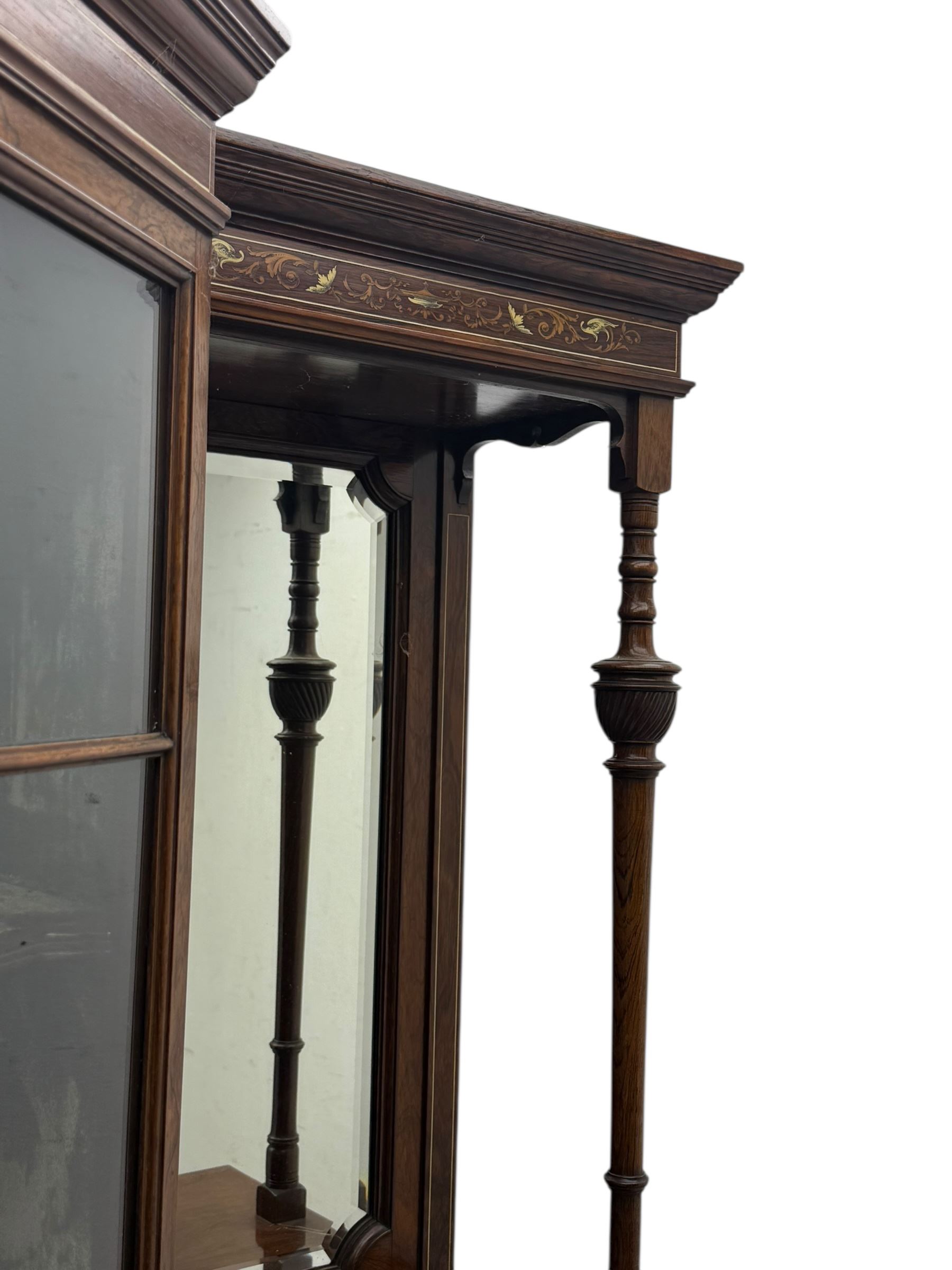 Victorian hardwood and inlaid display cabinet, central breakfront glazed display with astragal glazing and mirror back, flanked by mirrored alcoves with turned supports, below foliate and scrolling marquetry panels enclosing cupboard doors, shaped open shelves with turned supports beneath, on tapered and spade feet