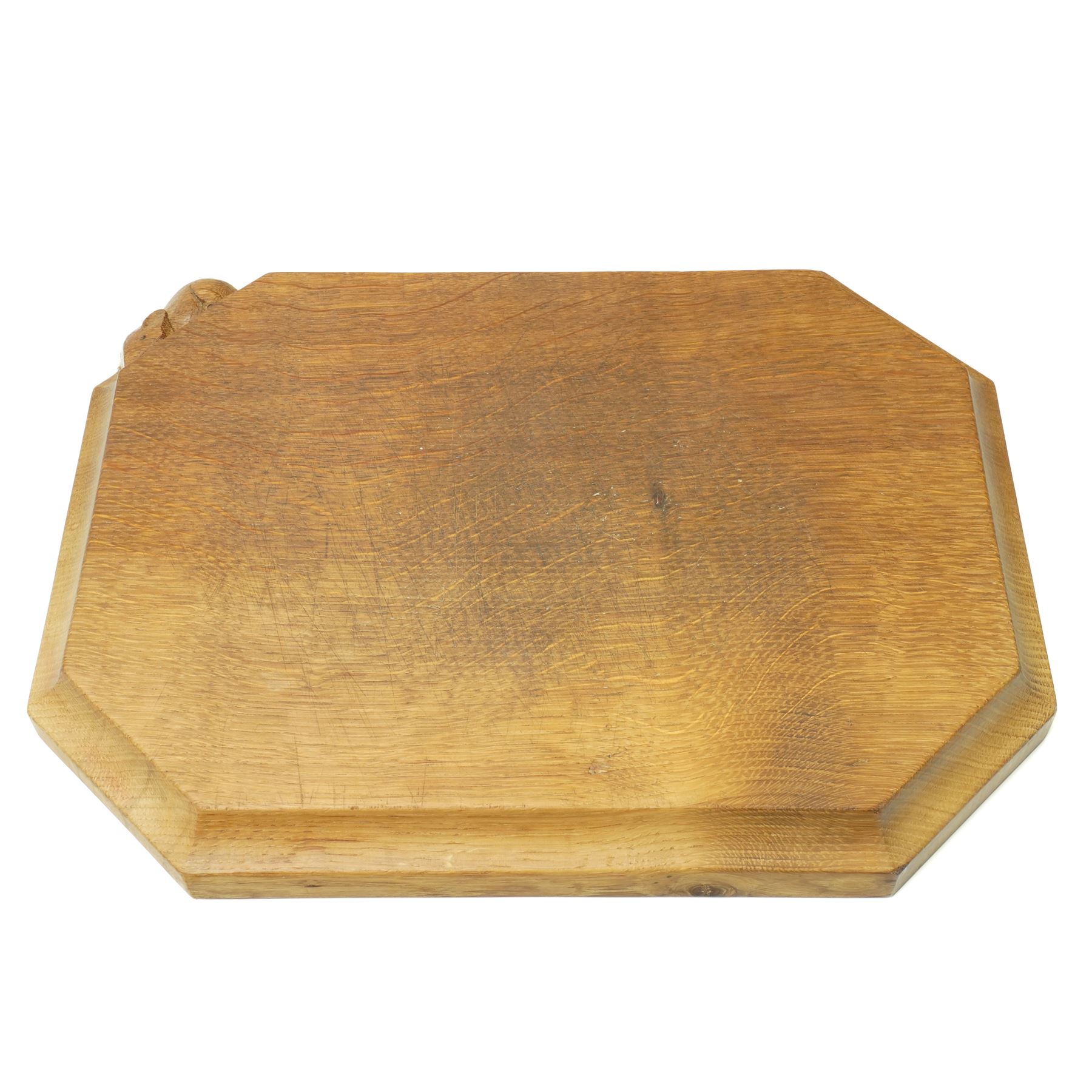 Mouseman - oak chopping board, of canted octagonal form with concave handles, with carved mouse signature, by the workshop of Robert Thompson of Kilburn