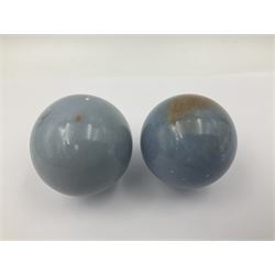 Pair of angelite spheres upon gilt metal stands, H8cm D6cm