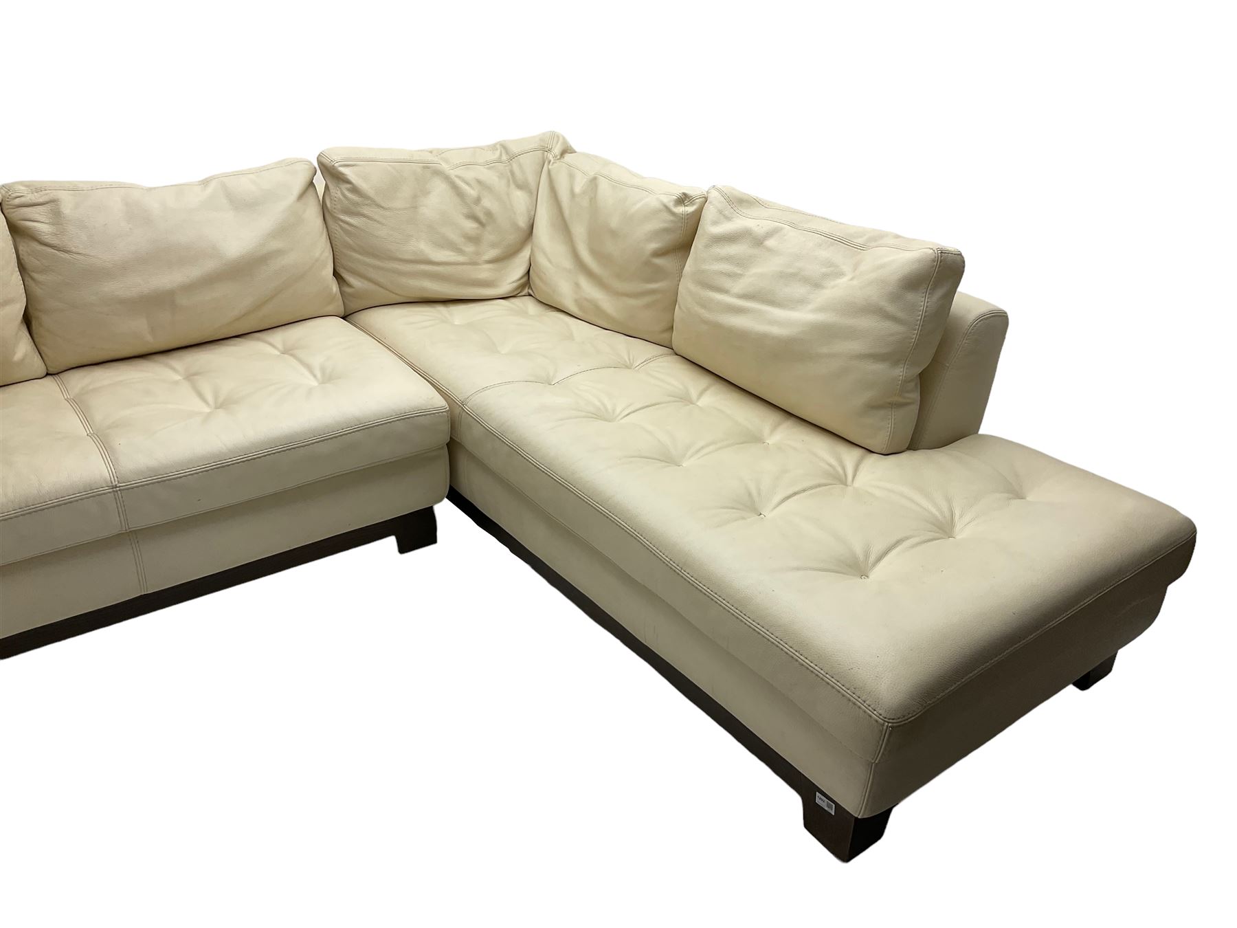 Roche-Bobois - large corner sofa, upholstered in ivory leather with buttoned seat cushions, raised on a stained beech base with bracket feet