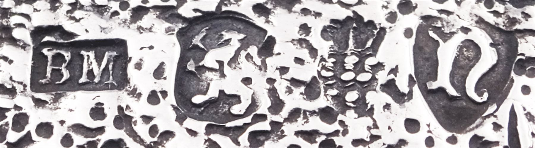 Late 19th century German Hanau silver box, of shaped rectangular form, embossed throughout, the hinged cover decorated with a central oval panel depicting a genre scene with musicians, the corners detailed with masks, the sides detailed with conforming figures and musical trophies, opening to reveal a gilt interior, with Hanau marks for Neresheimer & Sohne, and hallmarked B Muller & Son, London import 1907, approximate weight 3.32 ozt (103.4 grams)