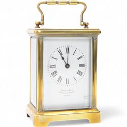 French-early 20th century carriage clock in a corniche case with an oval viewing glass and...